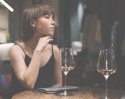 girl sitting in a restaurant with a glass